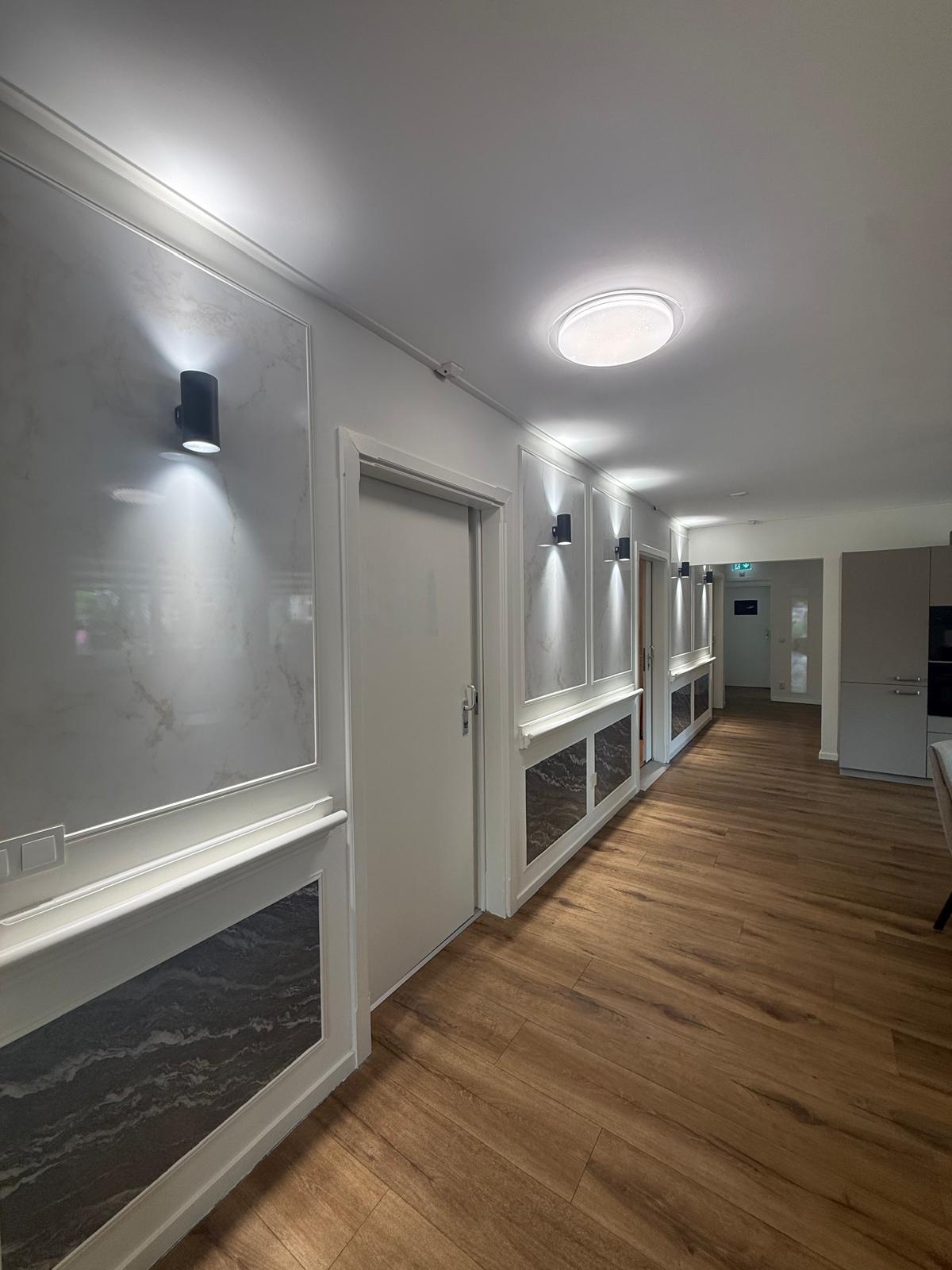 Verzorgde gang met sfeerverlichting naar de bewonerskamers